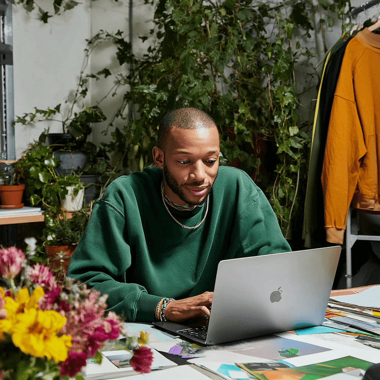 Person looking at laptop, smiling